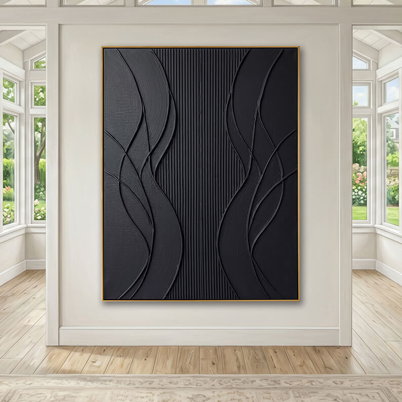The gold-framed black textured artwork is mounted on a central white accent pillar in a grand, sunlit room. Symmetrical floor-to-ceiling windows on both sides of the pillar reveal a lush green garden outside. The room features light natural wood flooring and a classic patterned rug in the foreground, creating a bright, airy, and upscale atmosphere that contrasts with the dark, bold artwork.