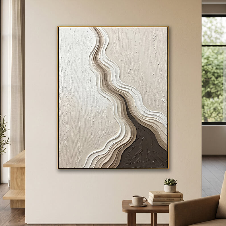 Minimalist beige and brown hand-painted abstract art displayed above a modern wooden side table in a cozy, neutral living room.