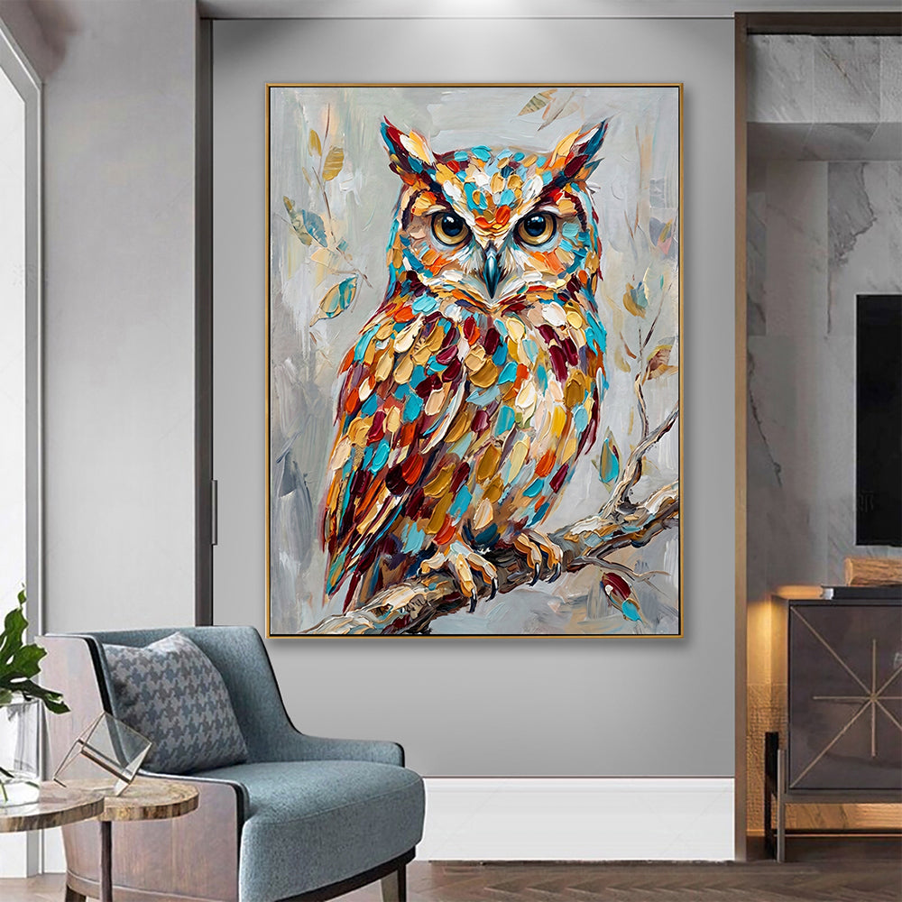 Contemporary living room setting showing a textured owl painting on a grey wall behind a blue armchair.