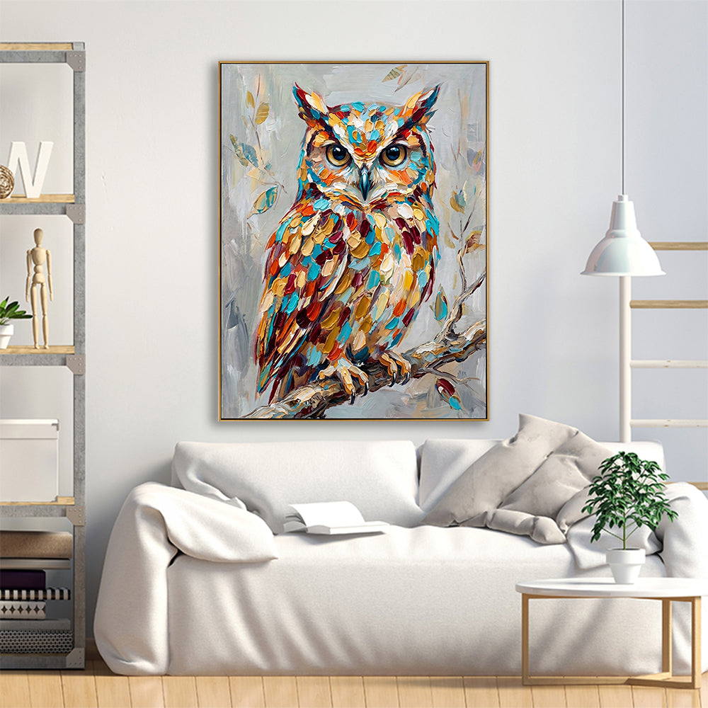 Bright living space with a large owl canvas art piece mounted above a white sofa with pillows.