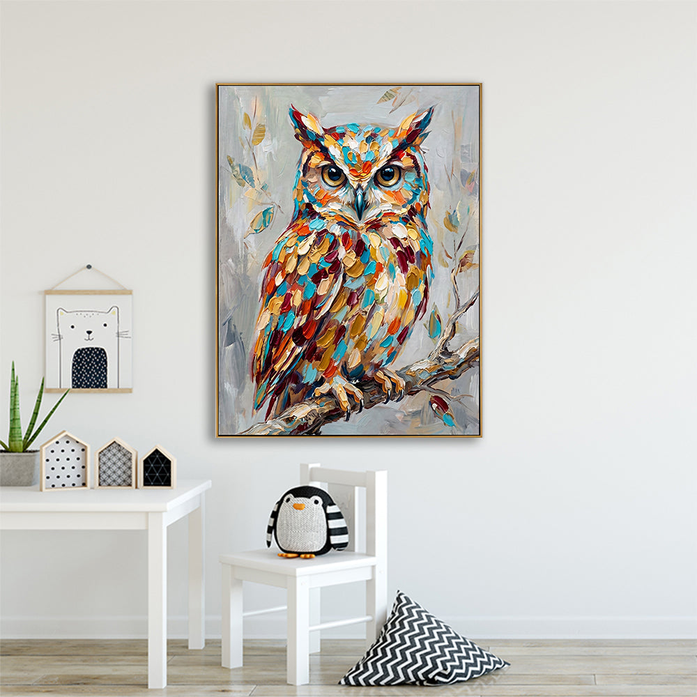 Charming nursery or playroom wall featuring a hand-painted owl art piece above a child’s white chair.