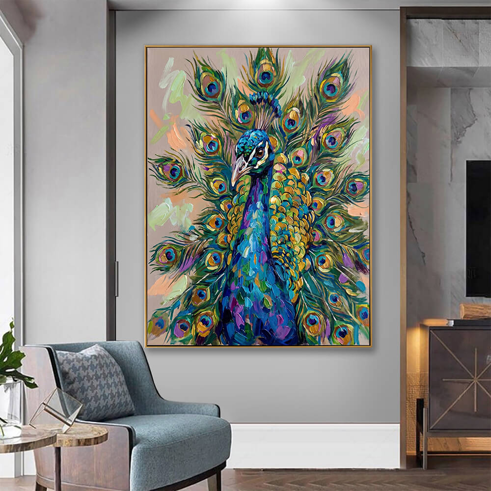 The textured peacock painting hangs centered on a soft sage green wall in a cozy, minimalist entryway or living space. Directly below the painting, a light natural wood bench serves as a shelf, holding a neat stack of books and a beautifully draped, textured off-white knit throw blanket.