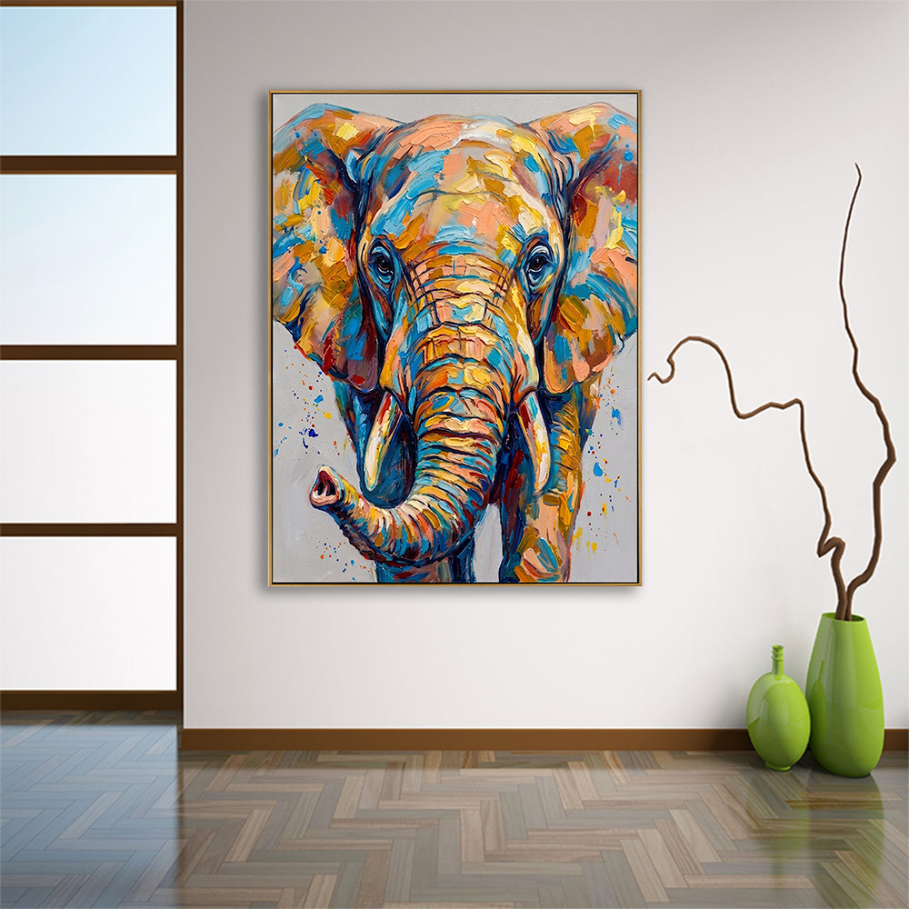Large colorful elephant art piece hung in a minimalist room with natural wood flooring and decorative green vases.