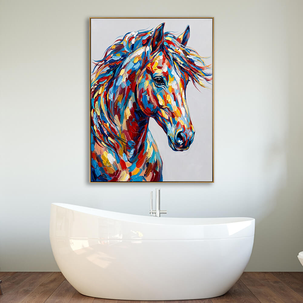 A spa-like modern bathroom setting featuring the horse painting hanging on a plain white wall. Below the canvas is a large, sculptural, white freestanding oval bathtub resting on dark, rich wood floorboards, showing how the colorful artwork can elevate a minimalist bathroom design.