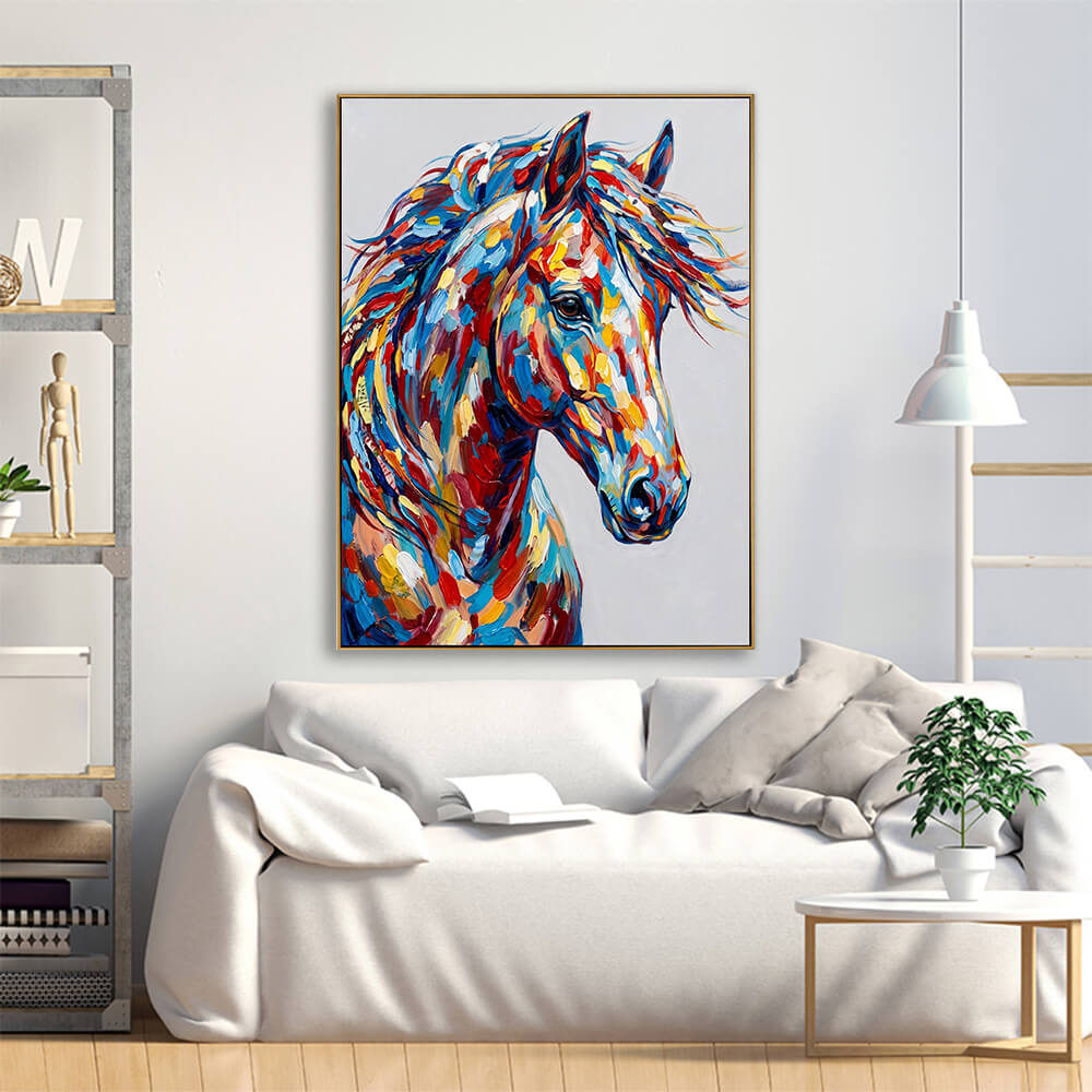 A bright, Scandinavian-style living room mockup. The large horse painting hangs centered above a plush, low-profile white sofa. To the left is an open industrial metal and wood bookshelf containing neutral decor, and to the right is a small round coffee table with a small green plant, lit by a minimalist white pendant light.