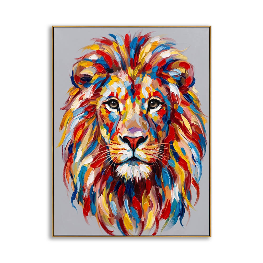 A vibrant, highly textured oil painting of a lion's face facing forward, rendered with thick palette knife strokes. The mane features a colorful explosion of red, blue, yellow, orange, and white paint against a neutral grey background, enclosed in a thin gold frame.