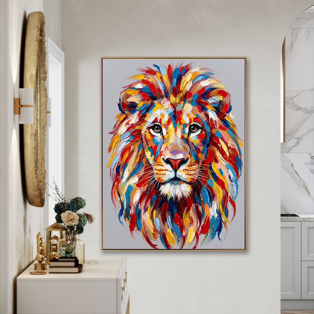 Modern hallway interior mockup showcasing a large, colorful textured lion painting in a gold frame hanging on a grey wall above a white console table decorated with books, a small vase, and a large round gold sculptural mirror.