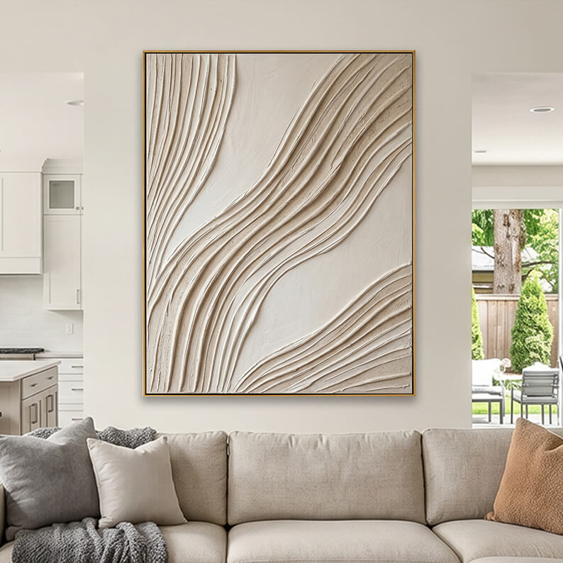 Cream colored heavily textured abstract canvas art styled above a beige fabric sofa in a contemporary living room.