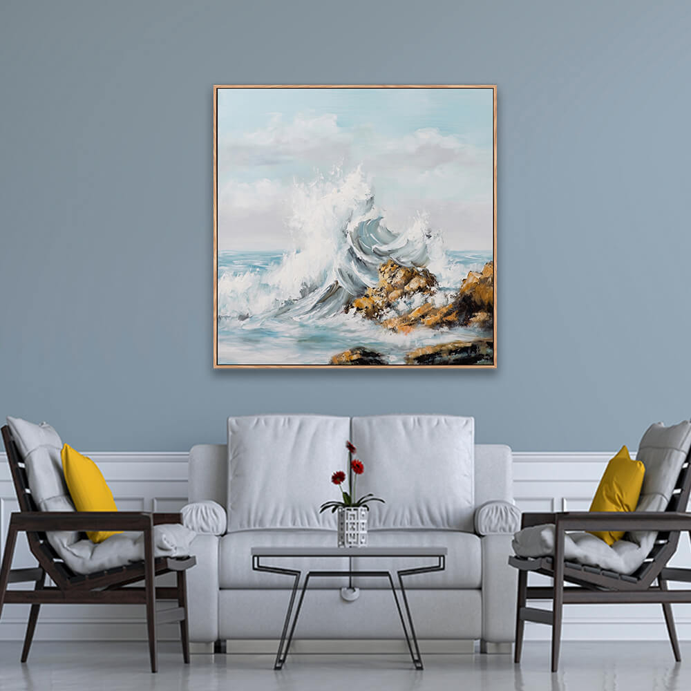 Striking crashing wave coastal landscape artwork hanging on light blue formal living room wall