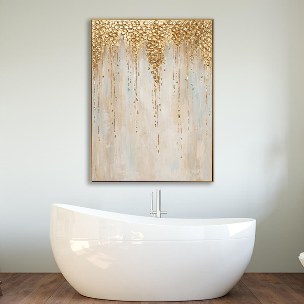 Neutral cream gold drip abstract canvas mounted above freestanding white bathtub in warm luxury spa bathroom