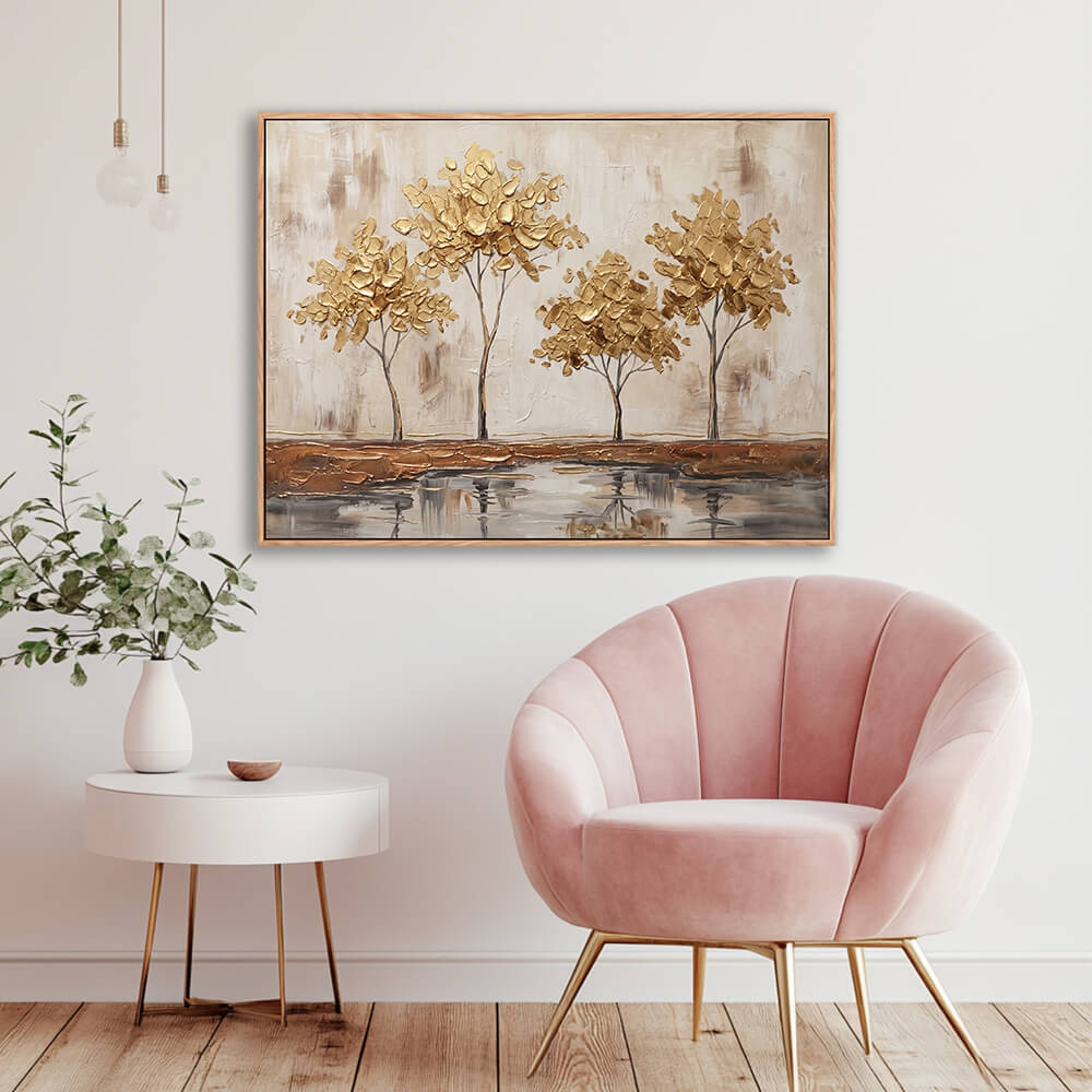 Textured gold trees artwork displayed in elegant room with pink velvet chair