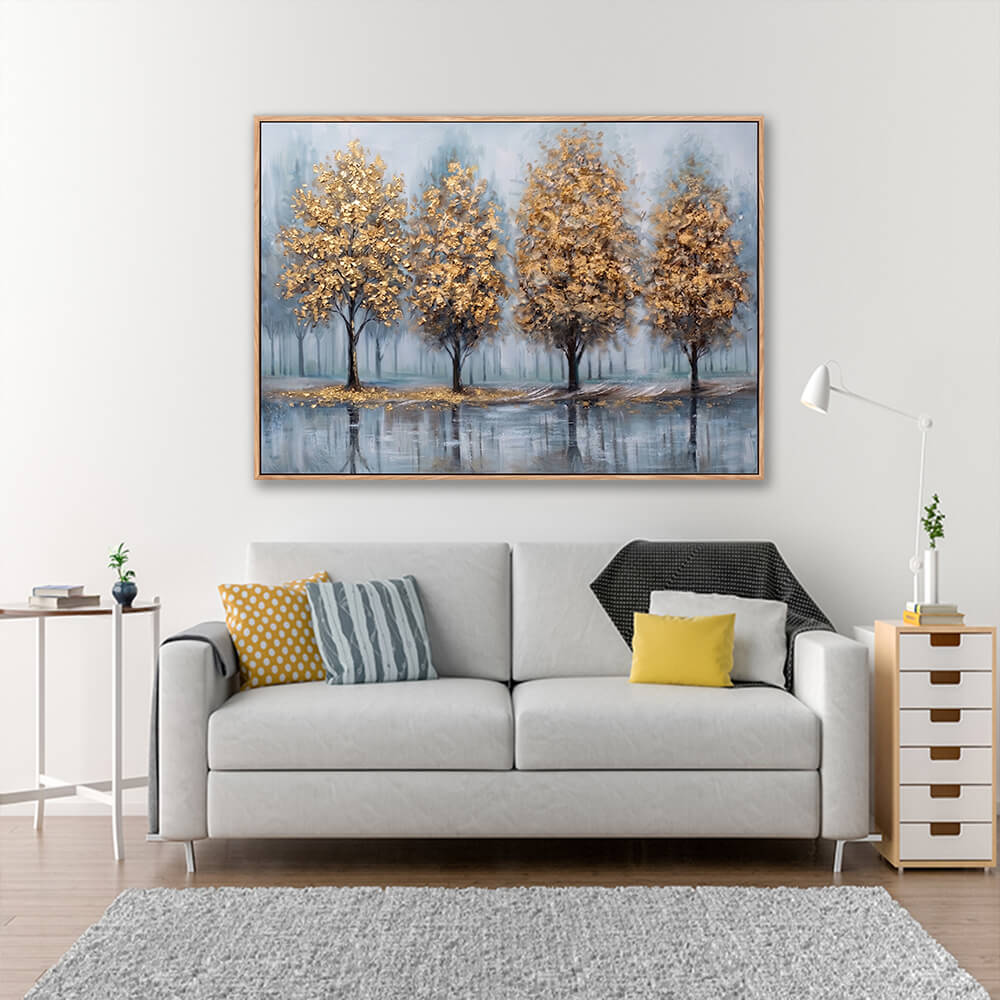 Hand painted golden forest landscape above grey sofa with yellow accent pillows