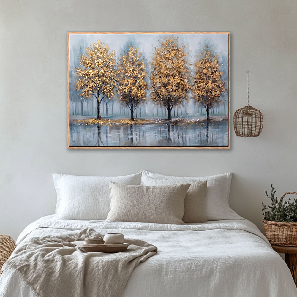 Golden trees misty forest wall art above bed in cozy neutral bedroom interior