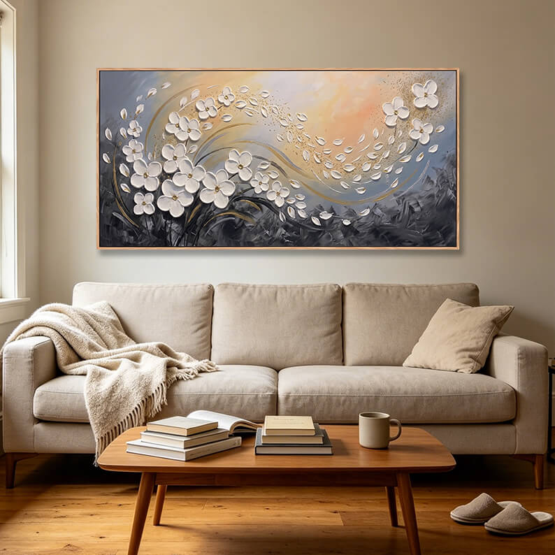 Shimmering textured abstract painting of flowing white flowers with metallic gold foil details under warm room lighting.