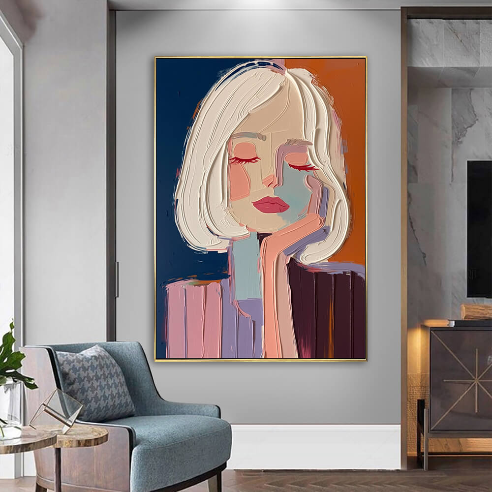 Textured palette knife portrait canvas art hanging on a neutral wall next to a cozy modern armchair and side table.