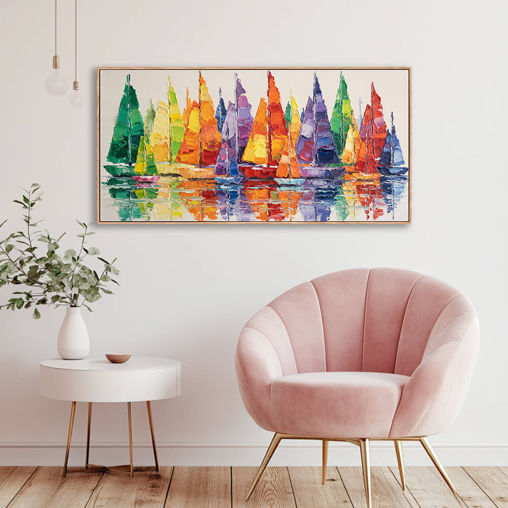 Wide rainbow regatta sailboat seascape artwork installed beside velvet accent chair for corner wall styling