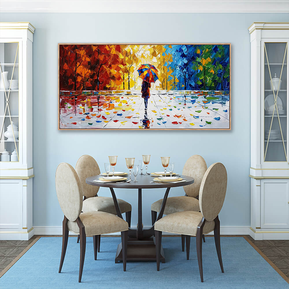 Horizontal textured autumn landscape painting hung in an elegant blue-walled dining room above a dark wood round dining set.