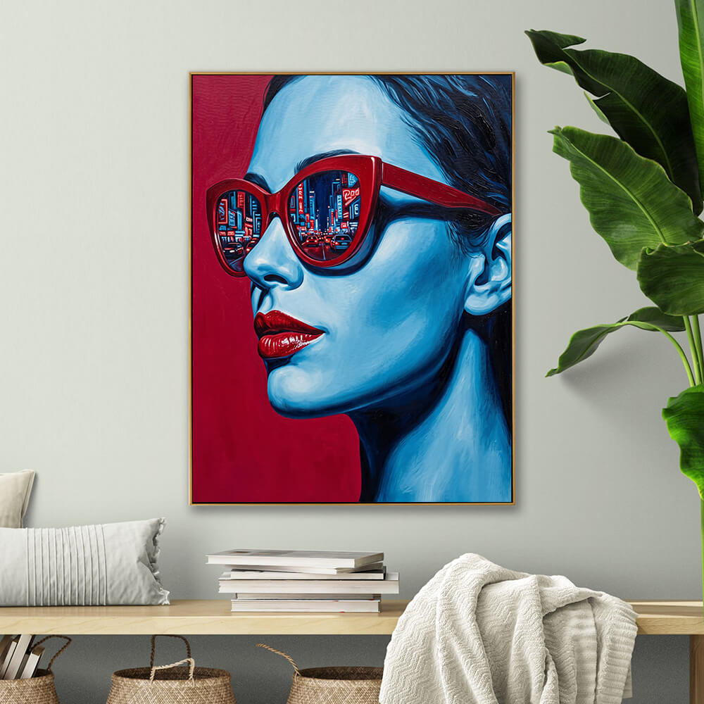Hand-painted fashion pop art canvas displayed above light wooden shelf with stacked books and woven storage baskets in neutral living room