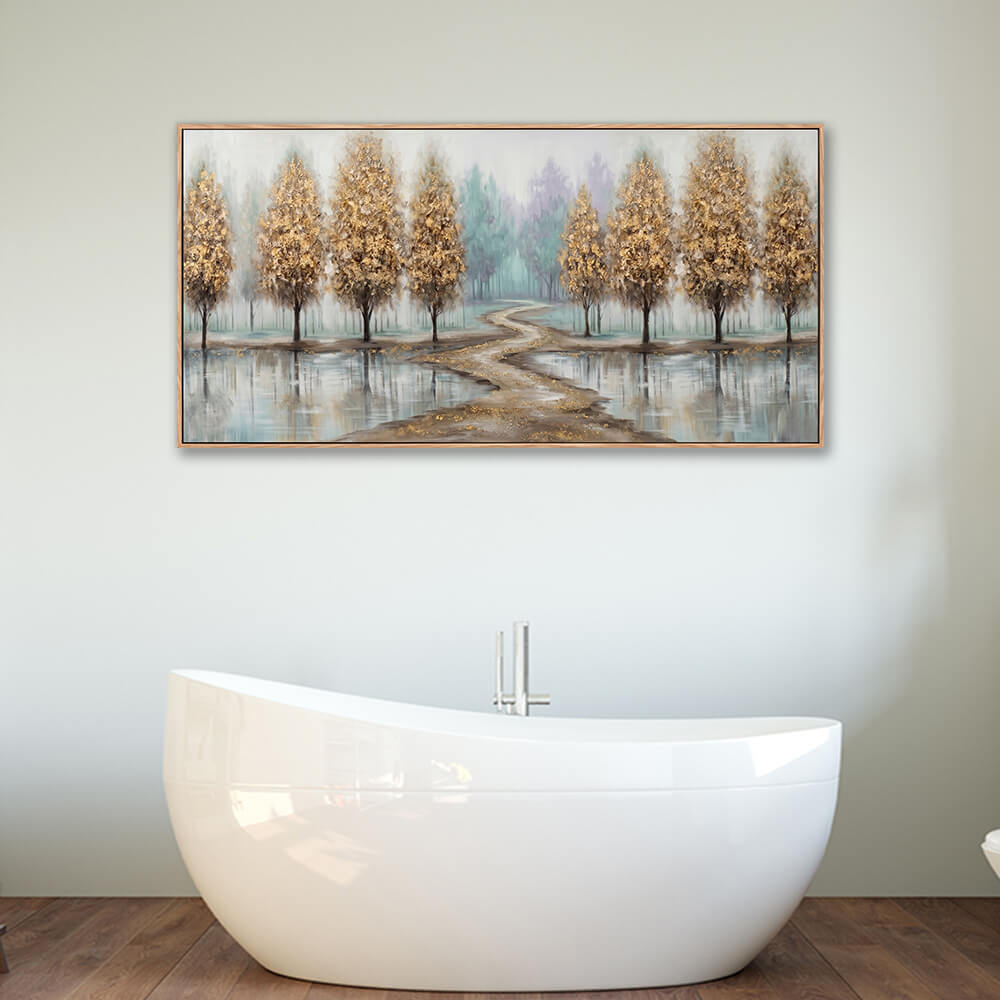 Large horizontal textured landscape painting with golden trees hanging on a grey wall above a freestanding white bathtub.