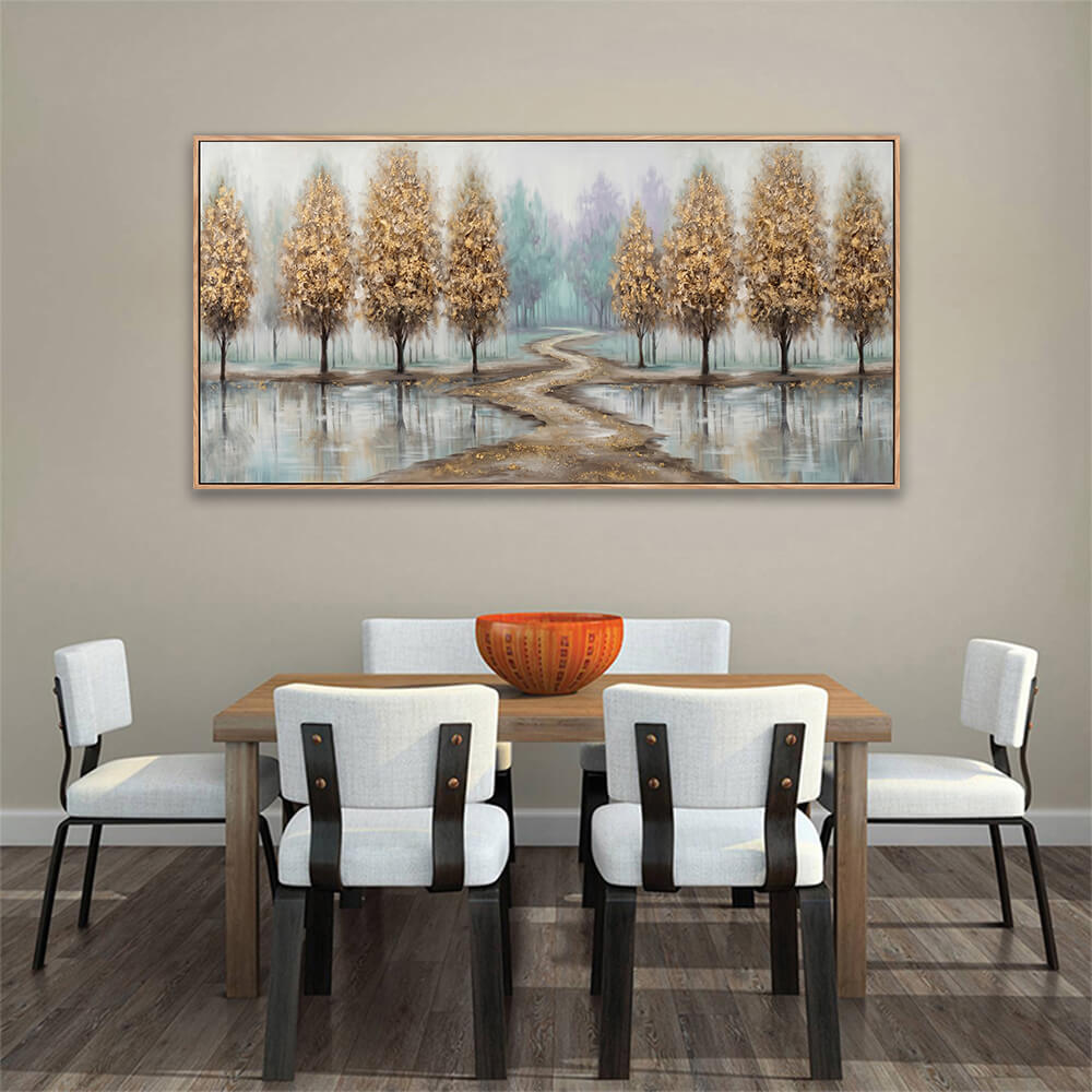 Horizontal hand-painted golden forest canvas art displayed above a modern wooden dining table with an orange bowl.
