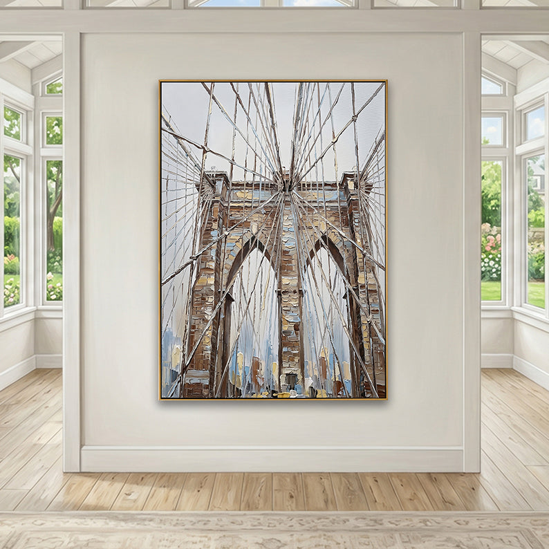 Spacious sunlit room with hardwood floors and a striking NYC bridge painting on a central gallery wall.