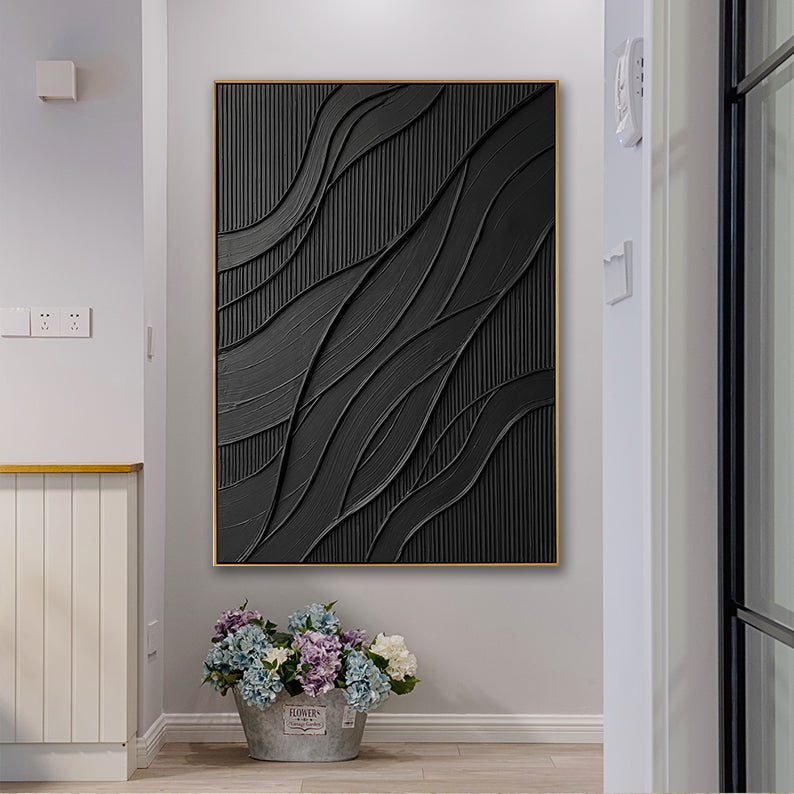 Modern black abstract wall decor styled above a rustic flower bucket.