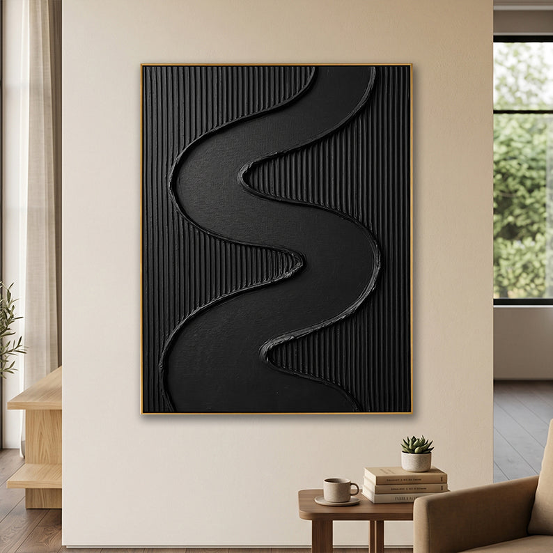 Vertical black 3D relief painting adding depth to a contemporary cream-colored living space.