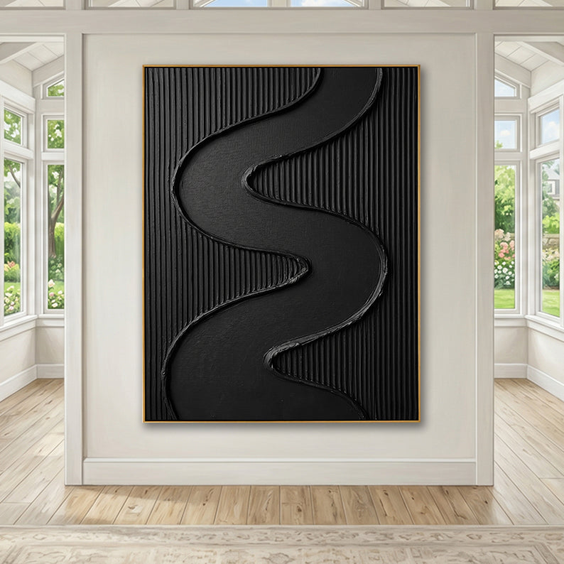 Statement black textured artwork framed by large windows in a sunlit open-concept room.