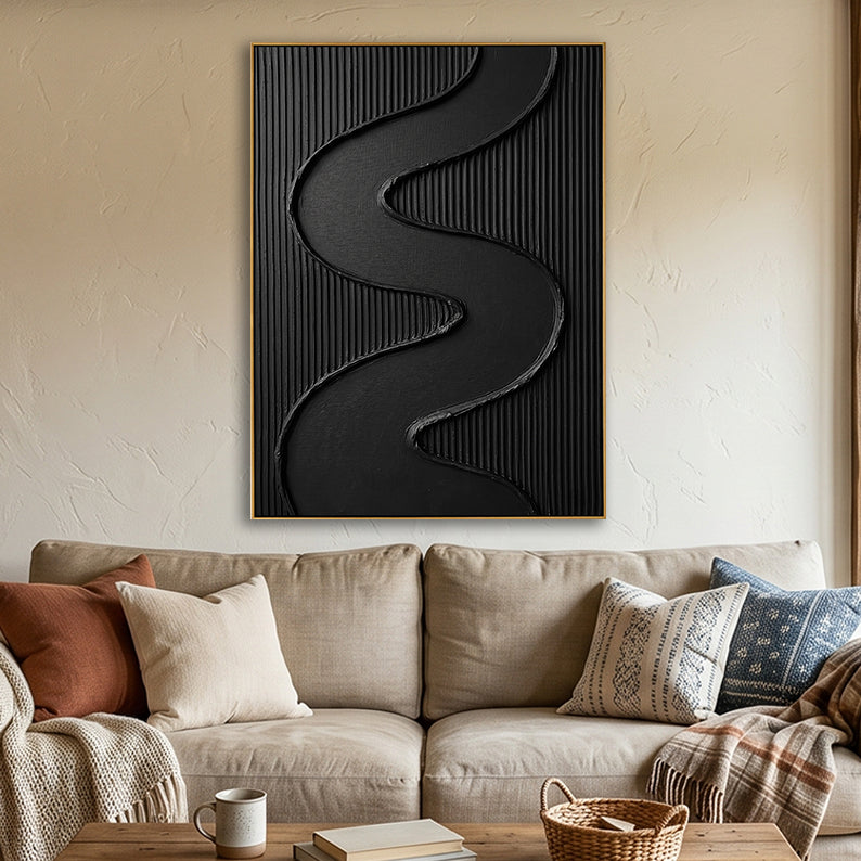 Hand-painted black wavy line art hung above a modern tan sofa with neutral accent pillows.