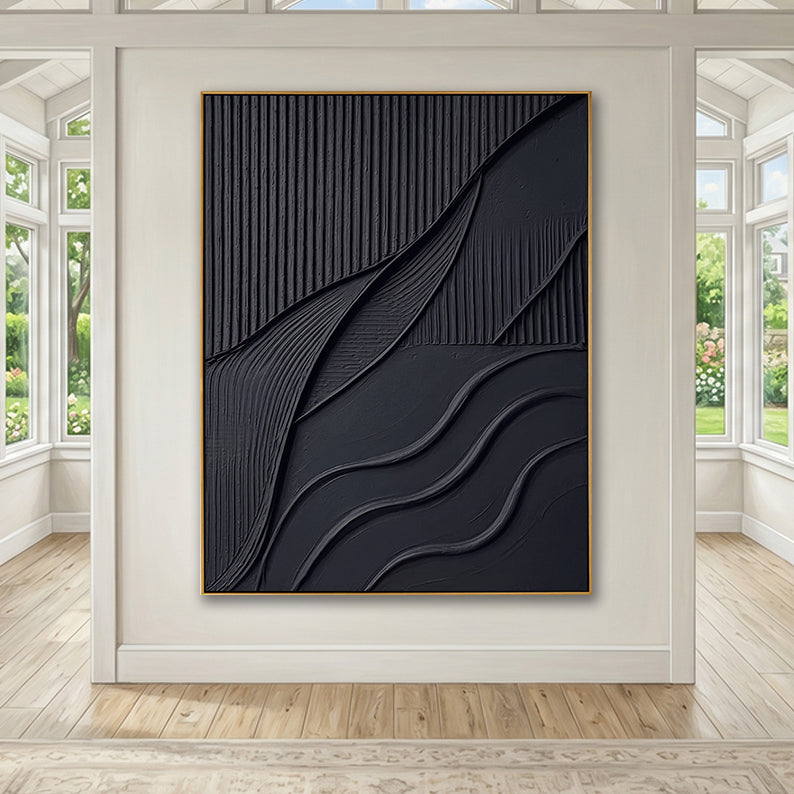 Statement black abstract textured painting displayed in a spacious, sun-drenched room with large windows.
