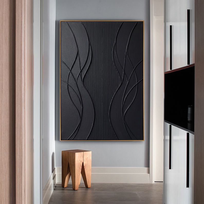 Hand-painted black minimalist artwork displayed at the end of a modern hallway next to a natural wood stool.