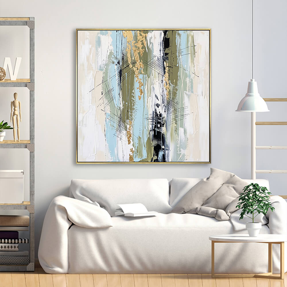 Muted pastel gold foil abstract canvas above cream linen minimalist sofa in scandinavian living room