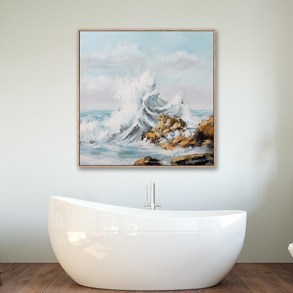 Framed crashing rocky wave seascape wall art hung above modern freestanding bathtub