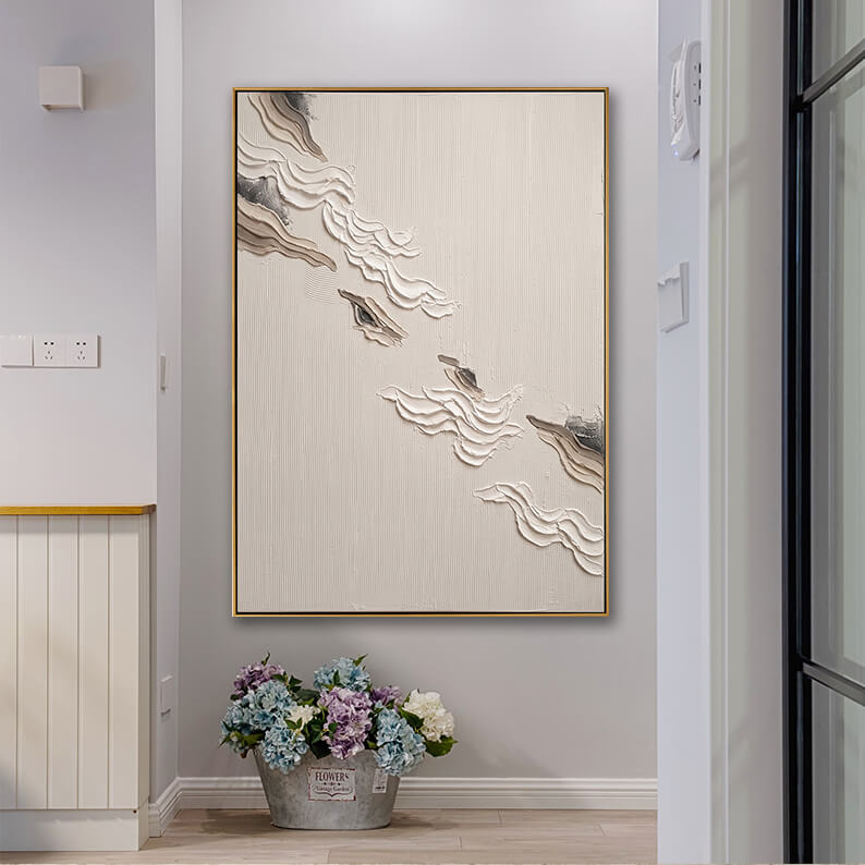 Elegant beige 3D textured abstract painting displayed in a bright modern home entryway with a beautiful hydrangea floral arrangement.