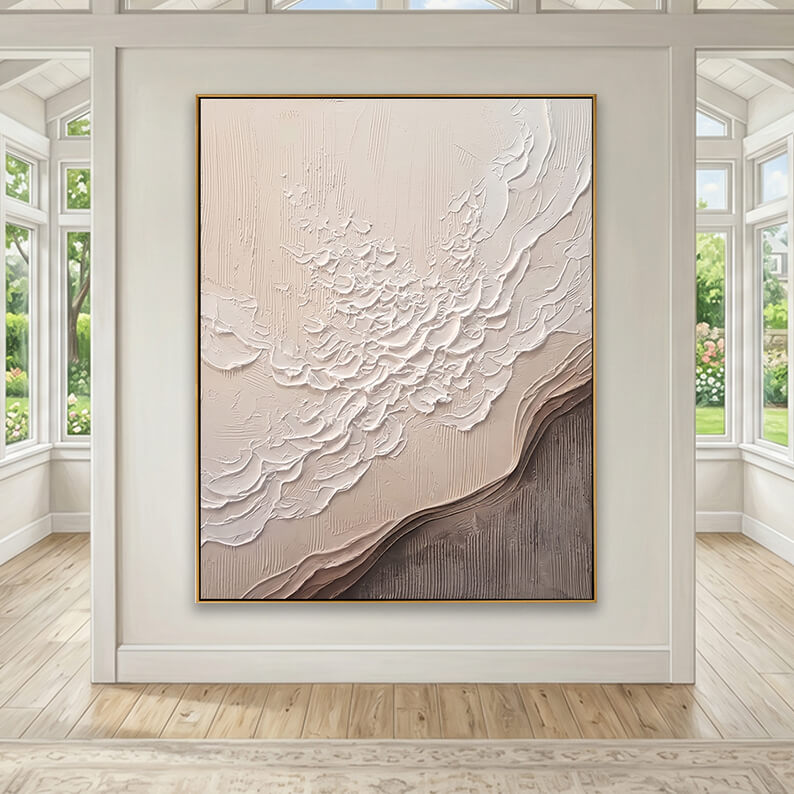 Elegant heavy impasto abstract painting in earthy taupe tones featured in a bright sunroom with wooden floors.