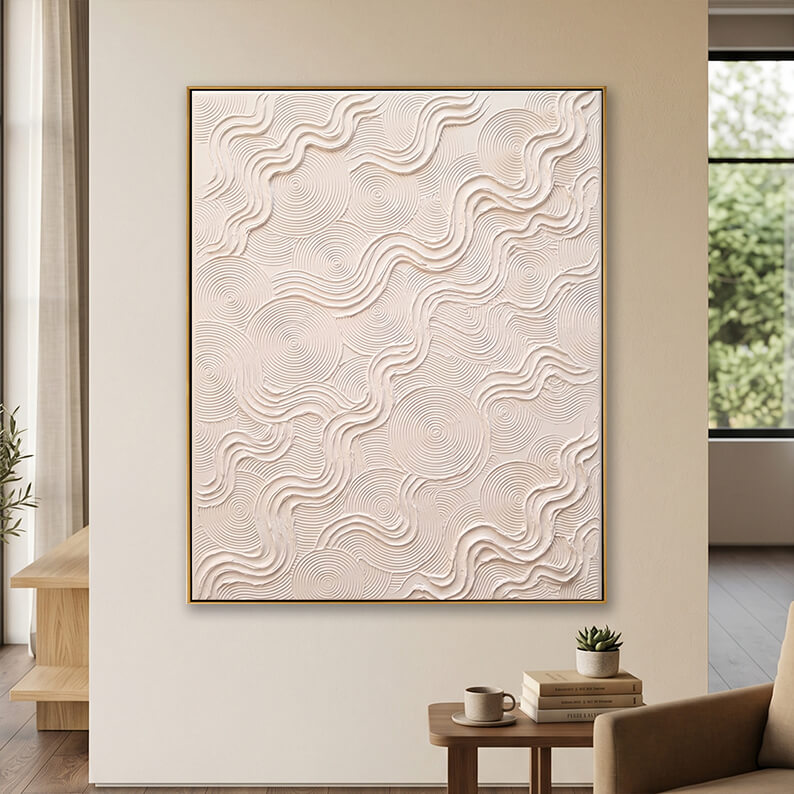 Zen wabi-sabi textured plaster wall art displayed in a bright minimalist reading nook next to a wooden side table.