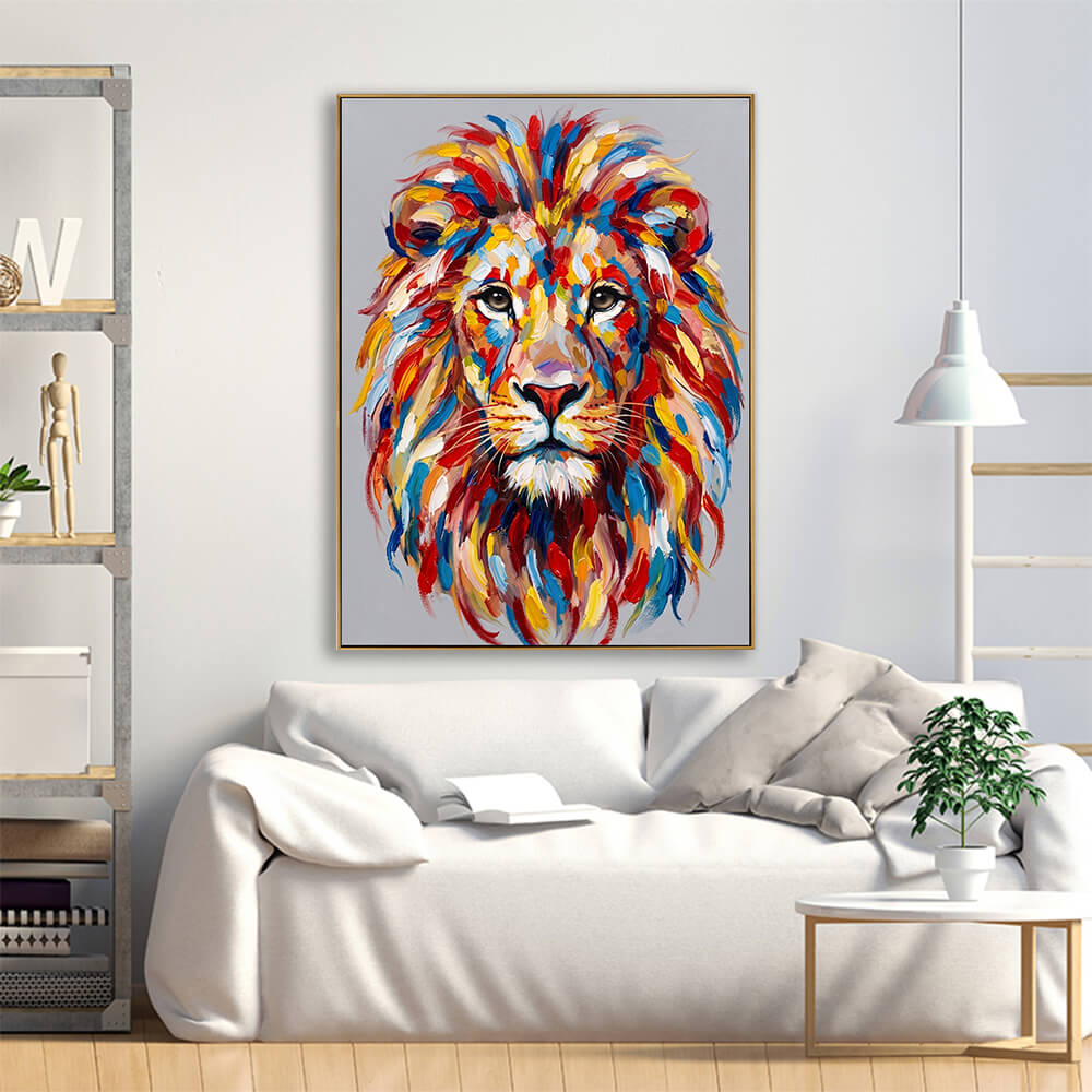 Scandinavian-style living room mockup displaying a colorful textured lion painting on a white wall above a plush white fabric sofa with decorative pillows, a wooden display shelf, and a white hanging dome lamp.