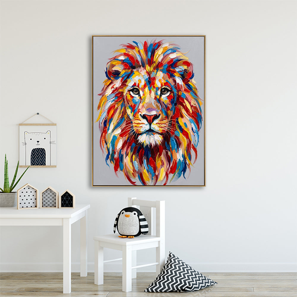 Abstract lion portrait displayed in a clean, white nursery or child's bedroom next to a small white chair and penguin toy.