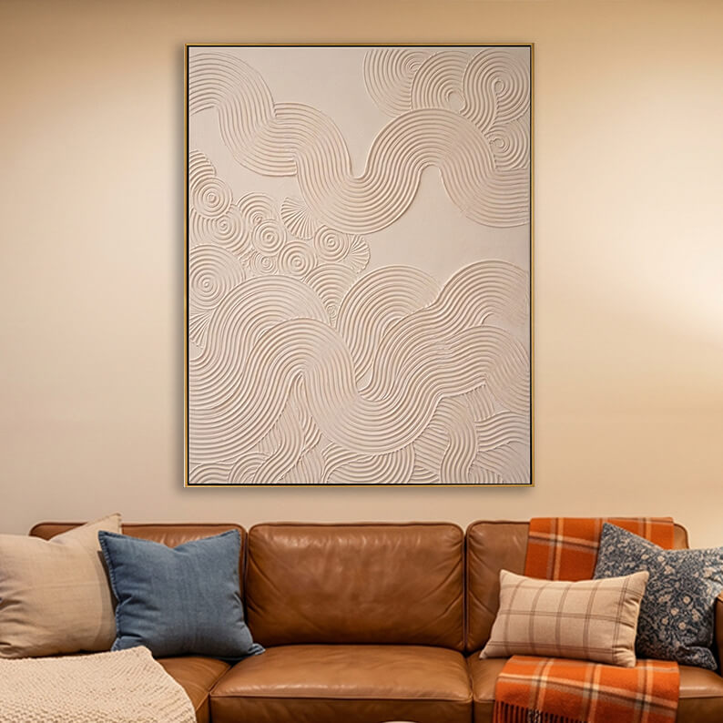 3D textured swirl wave painting hanging above a brown leather sofa in a warm modern living room.