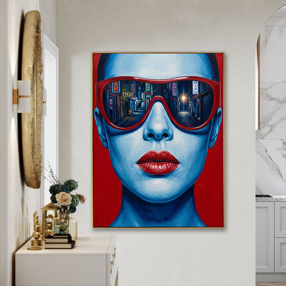 Vibrant pop art woman portrait canvas wall art hung in minimalist light entryway, matched with gold textured round mirror, white console table, dried flower vases and stacked hardcover books