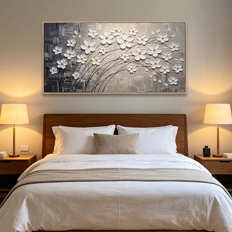 Panoramic horizontal textured white cherry blossom painting hanging elegantly above a wood-paneled headboard in a modern bedroom.