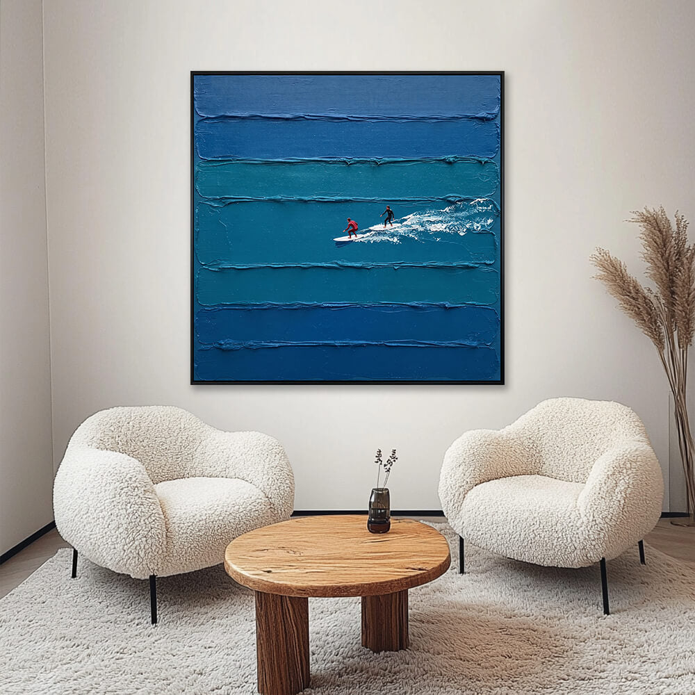 Interior styling view of Coastal Glide hanging in a cozy, cream-colored living room between two fluffy chairs and a wooden coffee table.