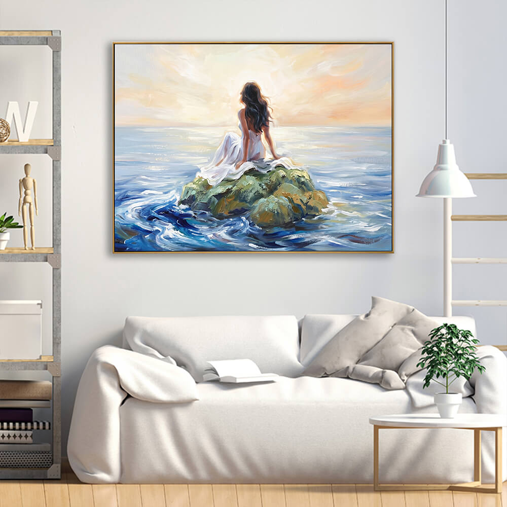 Textured hand-painted ocean woman canvas artwork displayed above cream linen sofa in bright minimalist living room