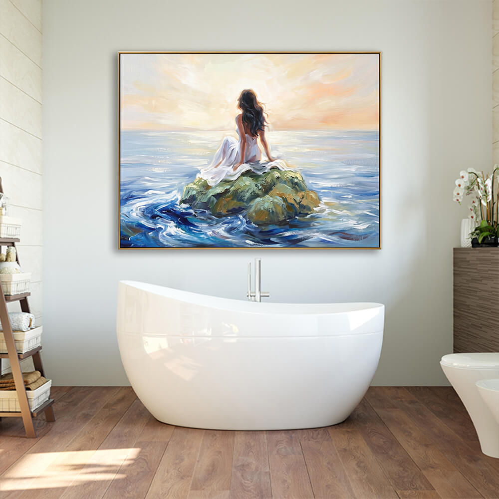 Hand-painted sunset woman ocean canvas wall art hung above freestanding white bathtub, wood flooring bathroom interior