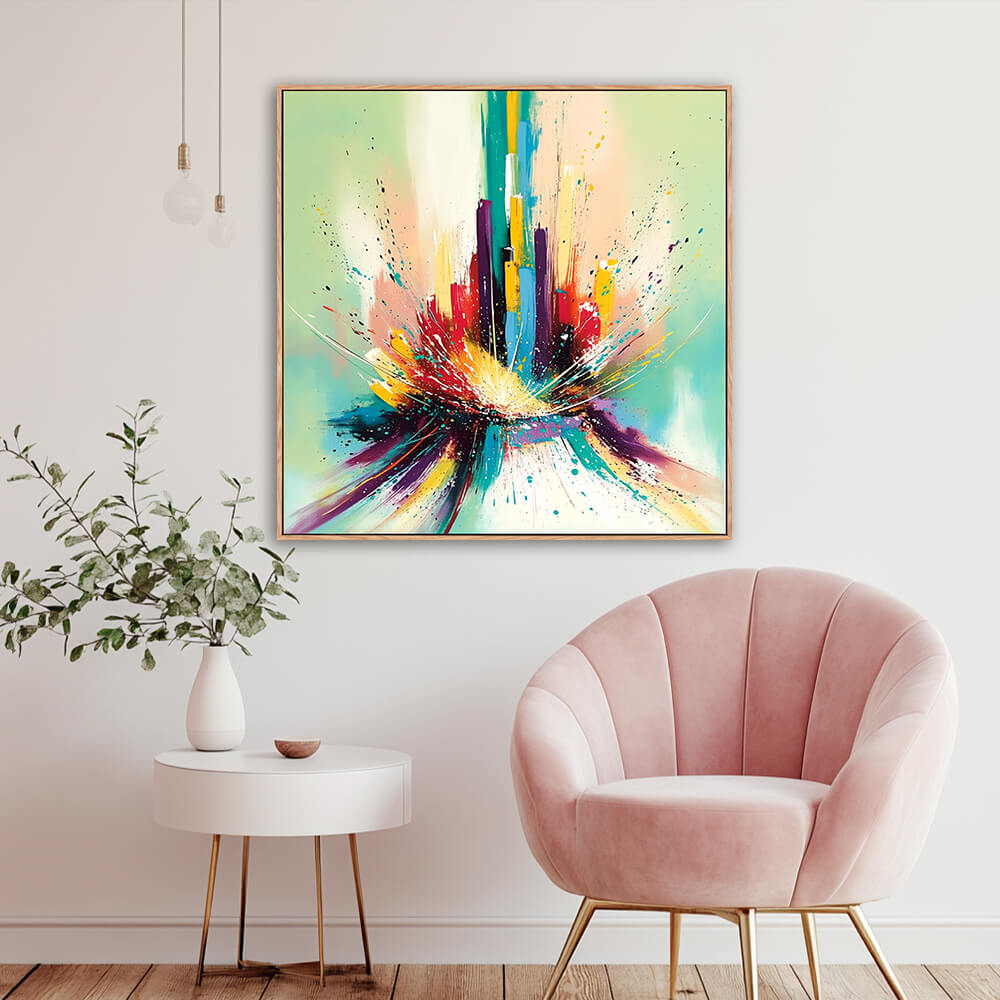 Hand-painted urban abstract cityscape canvas in cozy reading nook with blush pink velvet armchair, white round side table and eucalyptus greenery vase