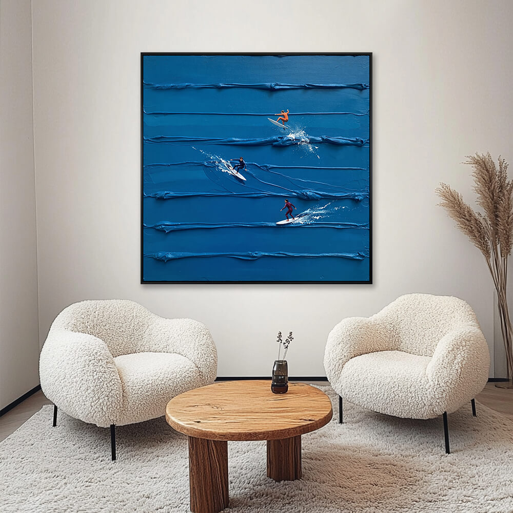 Interior styling view of Azure Surf Break hanging in a cozy, cream-colored living room between two fluffy chairs and a wooden coffee table.