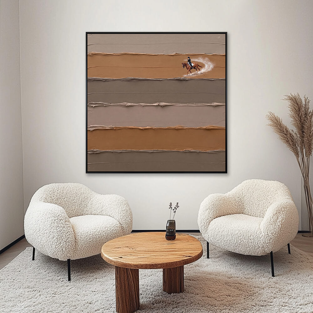 Interior styling view of Equestrian Elegance hanging in a cozy, cream-toned living room space positioned between two textured armchairs.