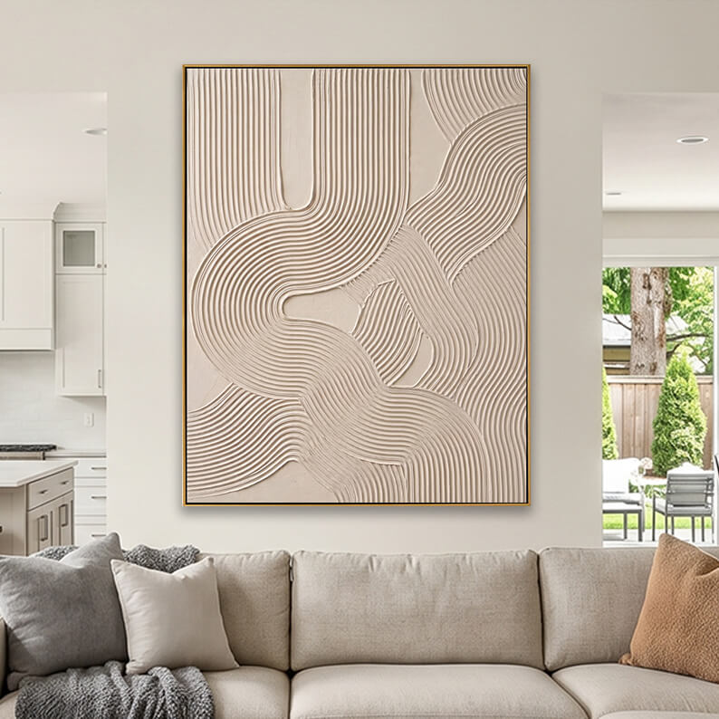 Cream colored heavily textured abstract canvas art styled above a beige fabric sofa in a neutral living room.