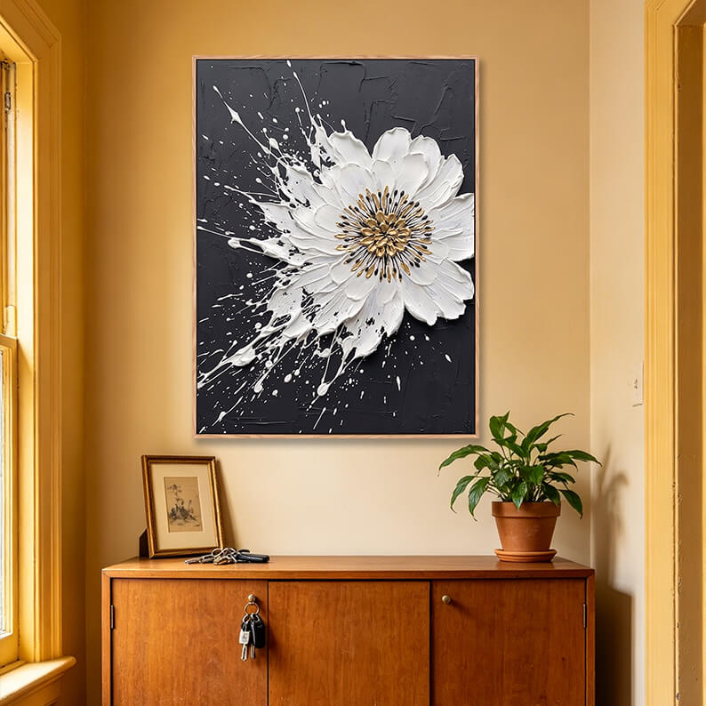 Vertical black white and gold 3D splash flower painting above wooden sideboard, heavy impasto modern artwork for entryway decor