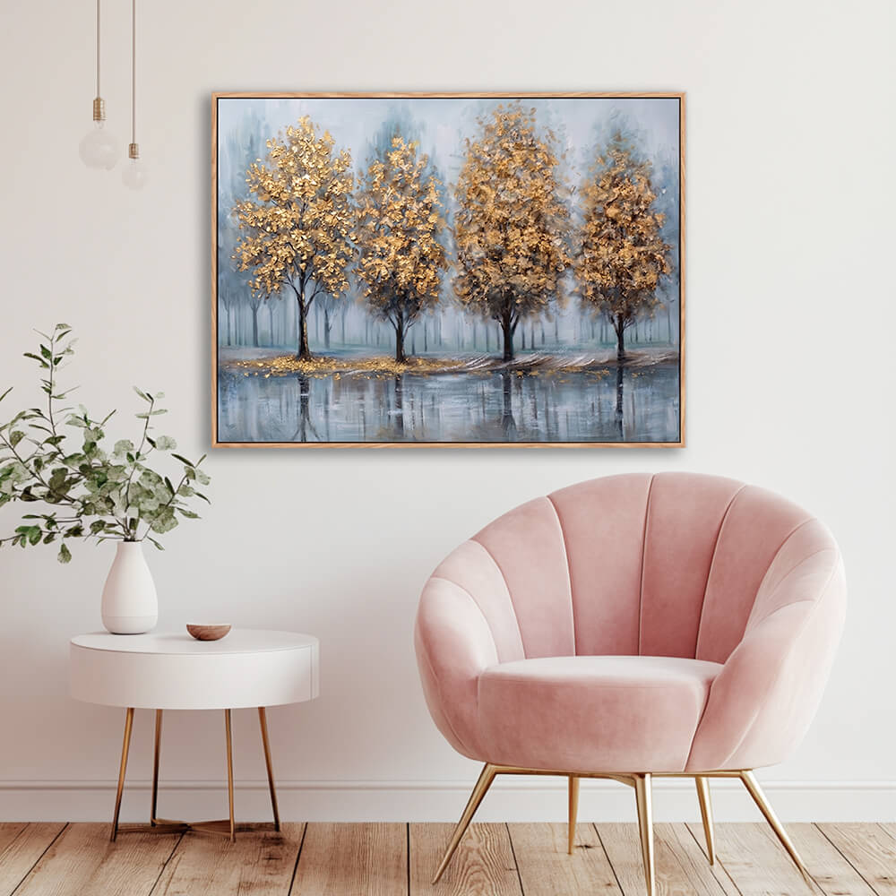Textured golden trees artwork displayed in elegant room with pink velvet chair